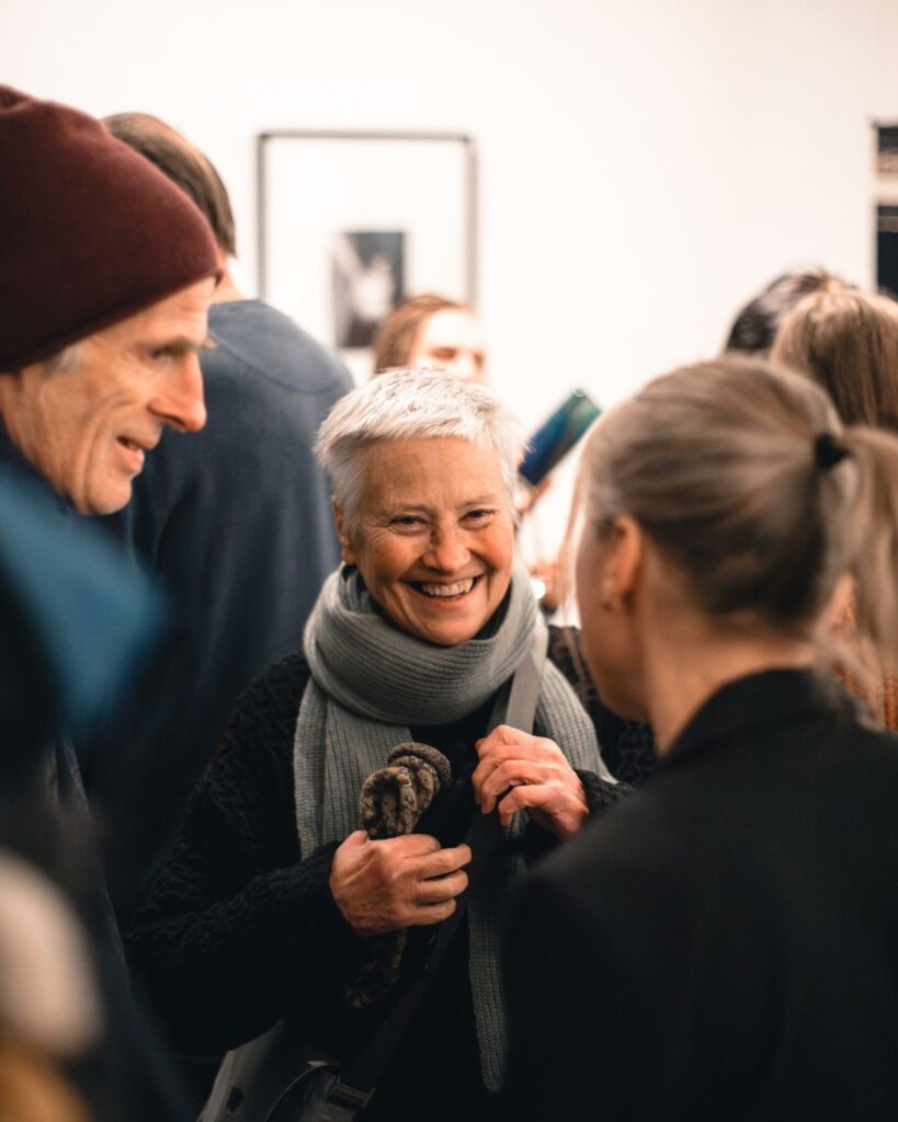 Besucher im Gespräch bei der Ausstellungseröffnung vom ersten POP-UP KunstMarkt in Graz, präsentiert von den Künstlerschwestern Sandra Wiedner und Mirjam Schrei.